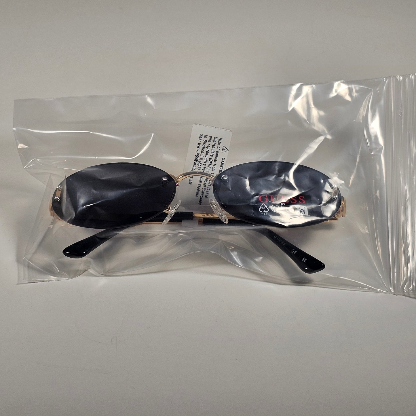 Guess GO00082 32A Small Rimless Oval Sunglasses Gold Frame Gray  Tinted Lens